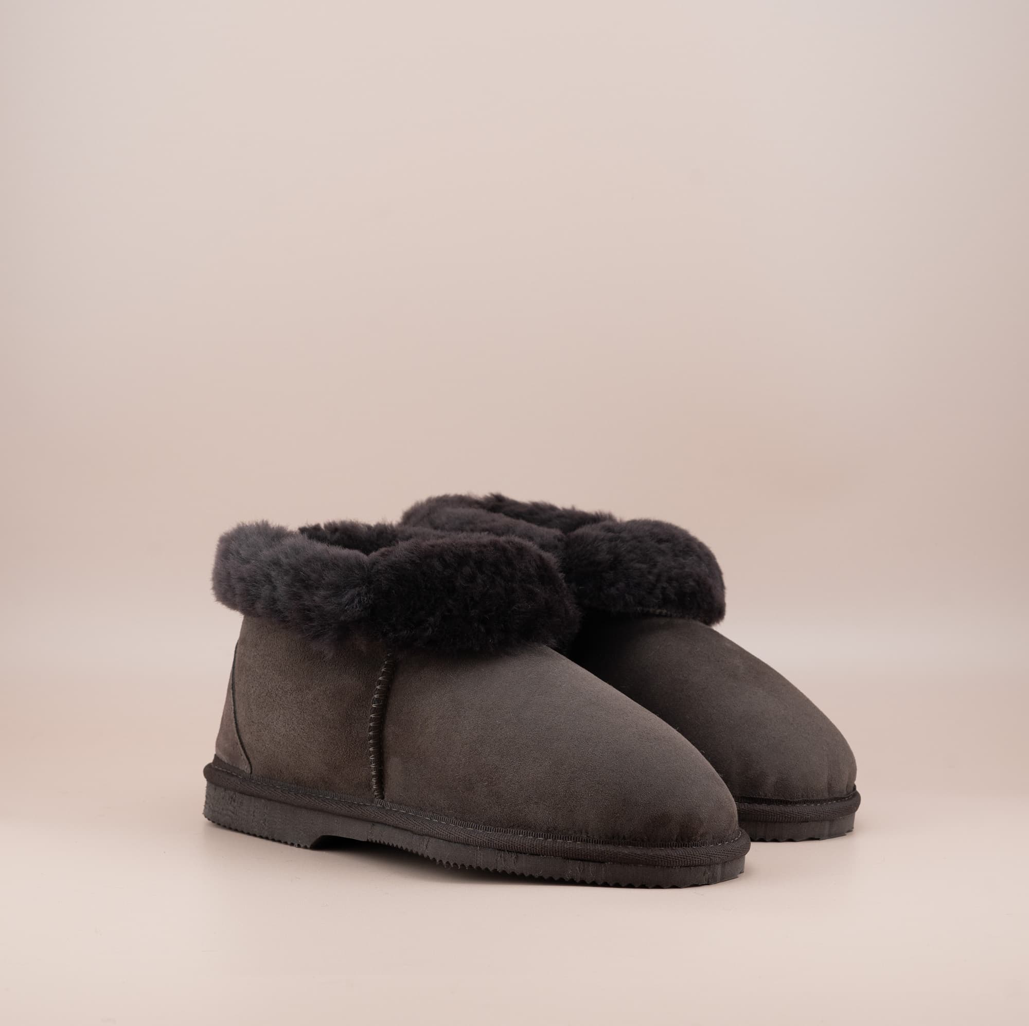 Men's ugg slippers with a suede finish in chocolate and wool turn, side view of the pair. #color_chocolate