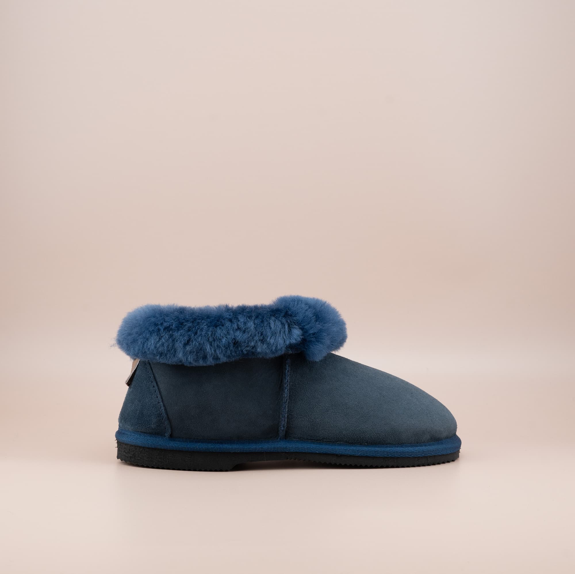 Men's ugg slippers with a suede finish in navy and wool turn, single side view. #color_navy