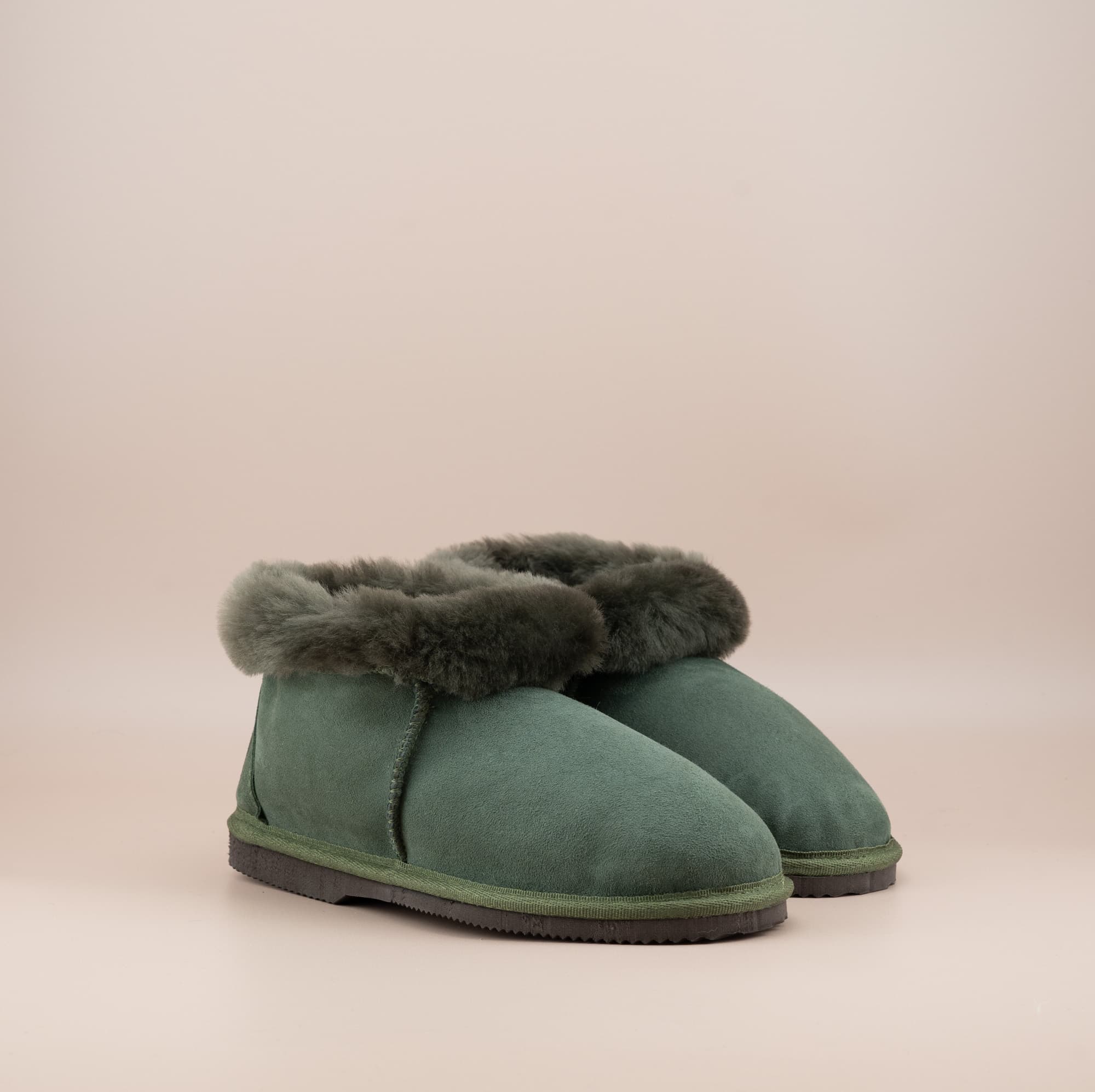 Men's ugg slippers with a suede finish in olive and wool turn, side view of the pair. #color_olive