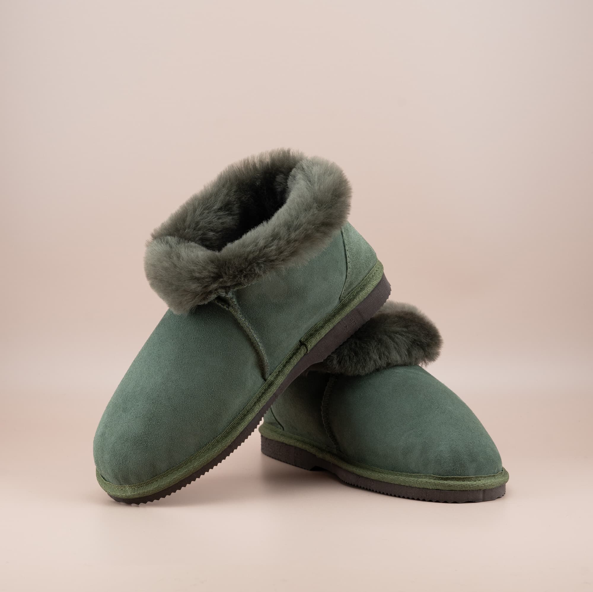 Men's ugg slippers with a suede finish in olive and wool turn, front and side view. #color_olive