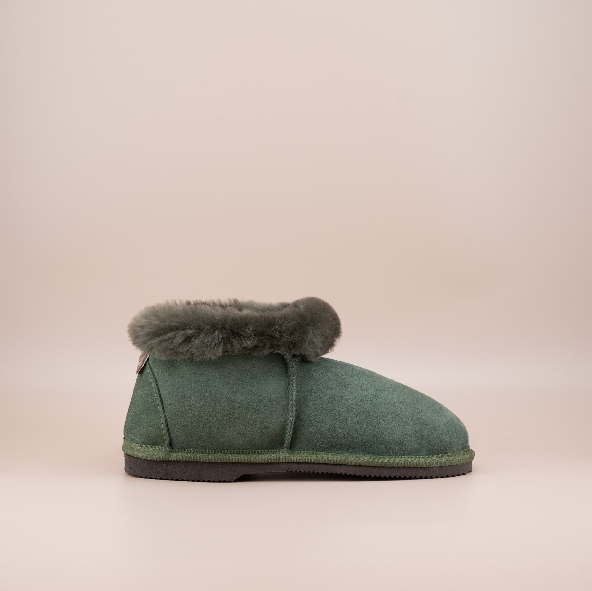 Men's ugg slippers with a suede finish in olive and wool turn, side view. #color_olive