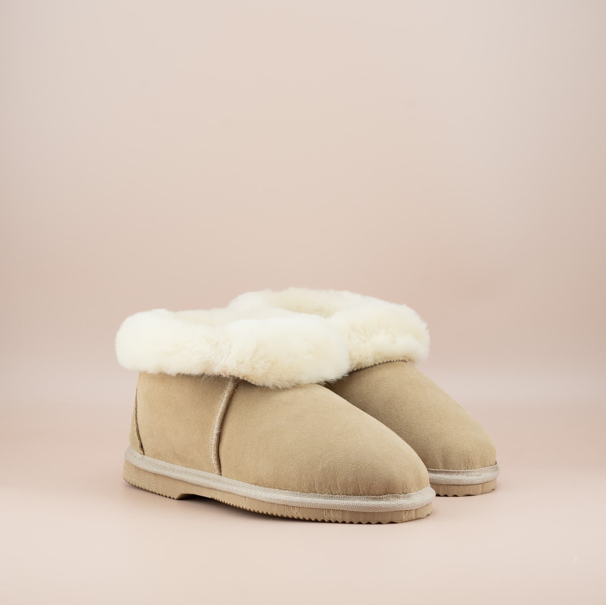 Men's ugg slippers with a suede finish in sand and wool turn, side view of the pair. #color_sand