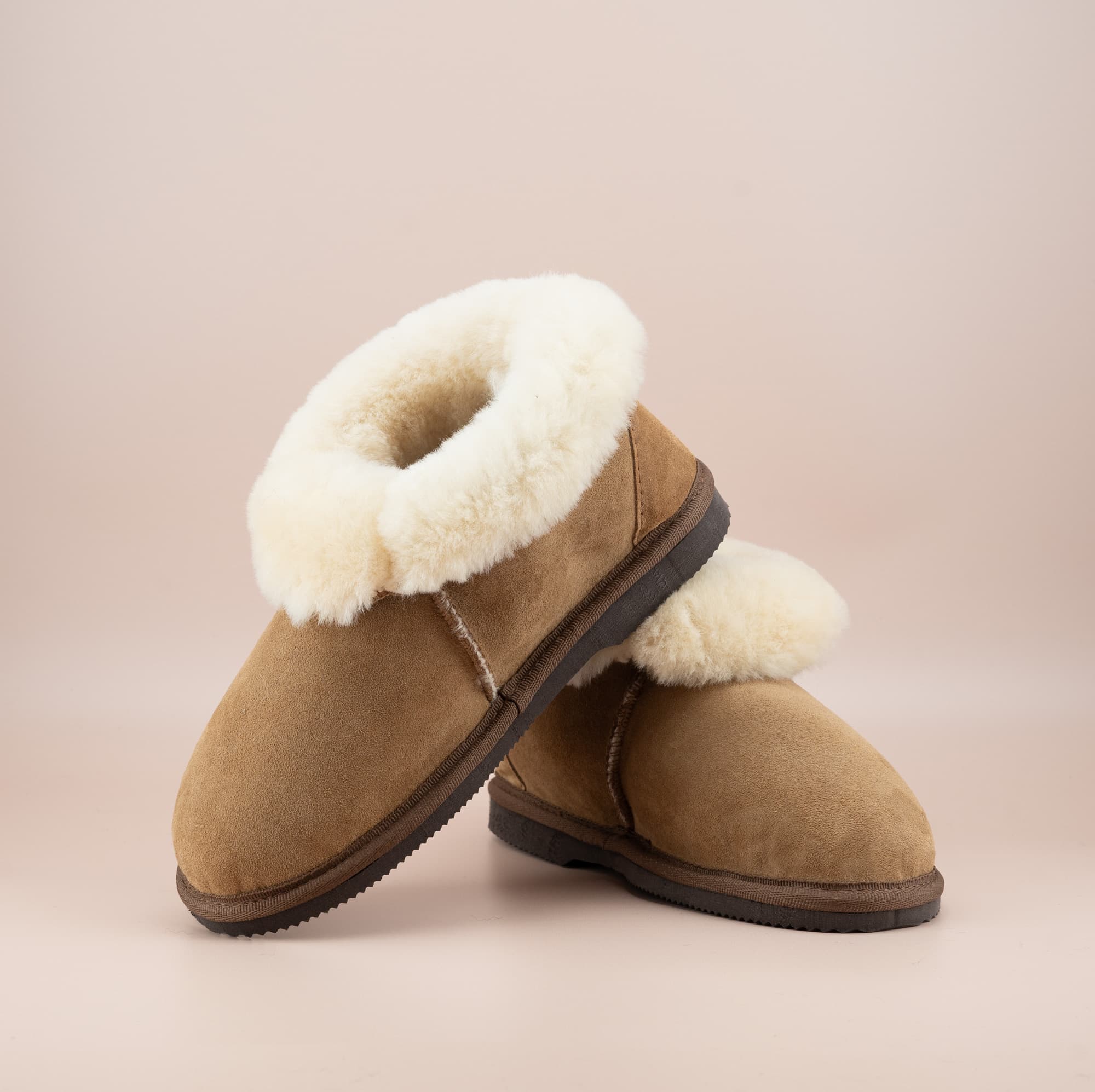 Men's ugg slippers with a suede finish in tan and wool turn, front and side view. #color_tan