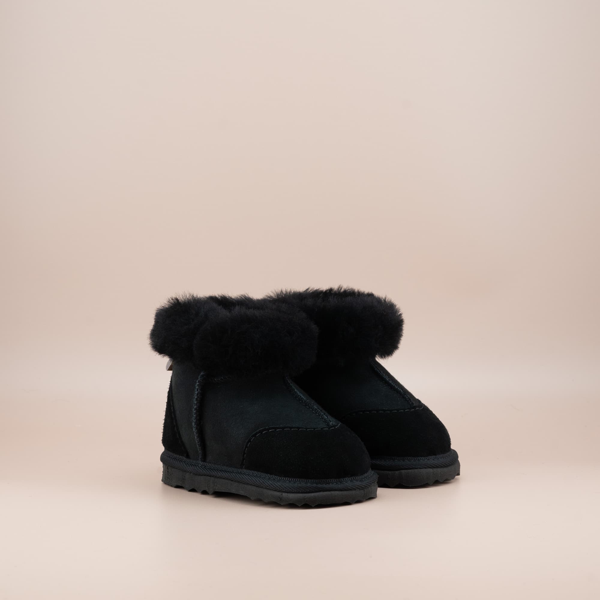 Toddler's ugg boots in soft suede black with wool turn, front side view. #color_black