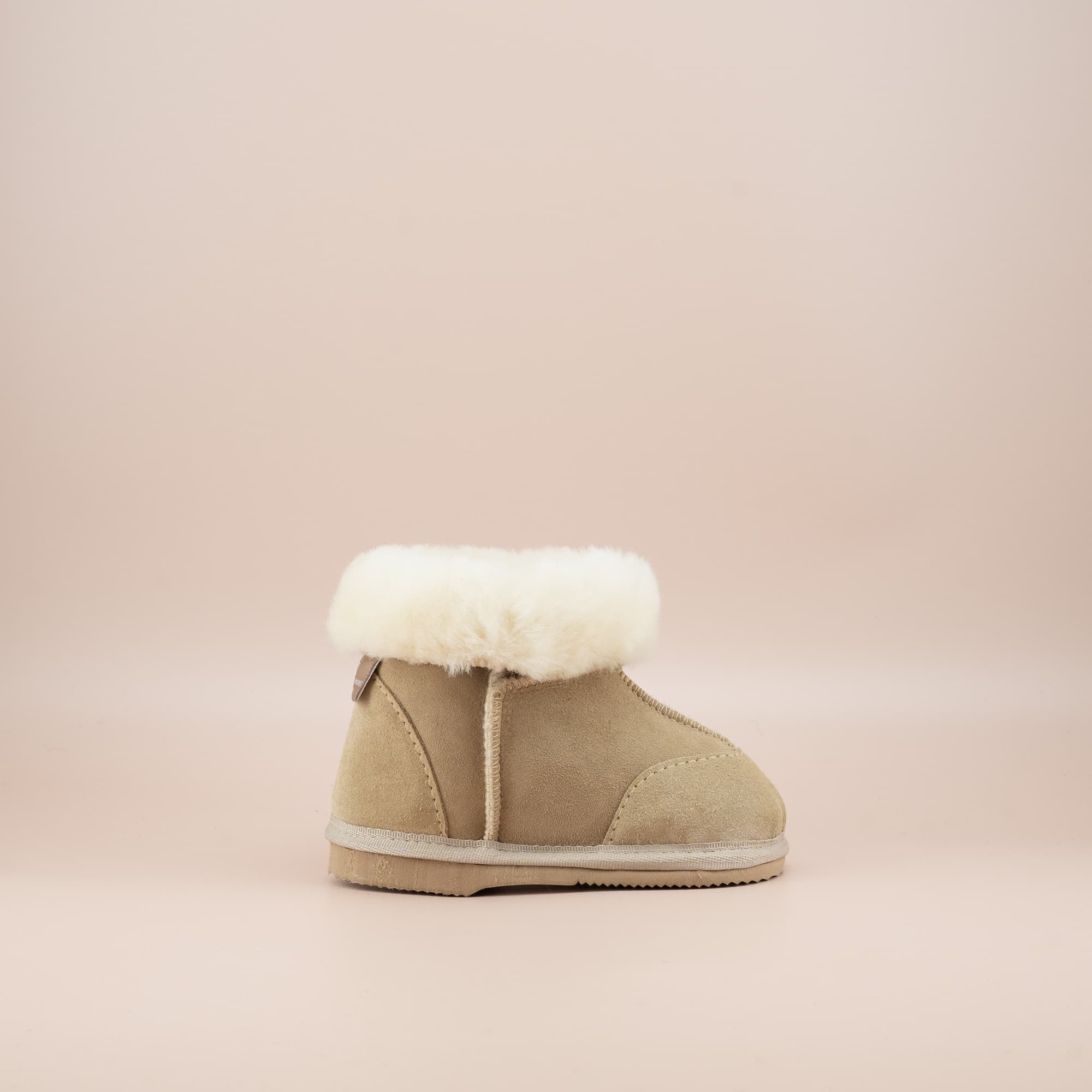 Toddler's ugg boots in soft suede sand with wool turn, side view. #color_sand