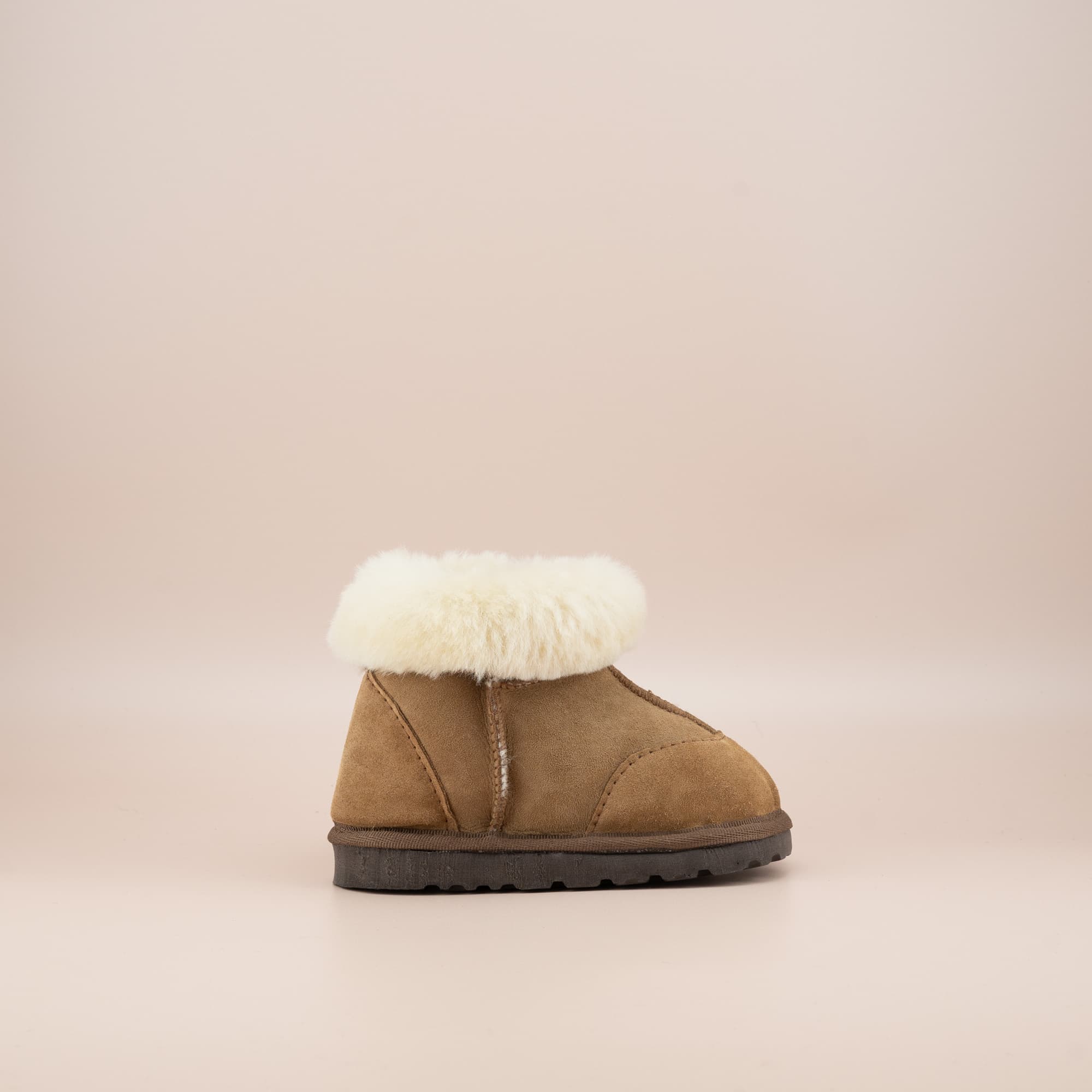 Toddler's ugg boots in soft suede tan with wool turn, side view. #color_tan