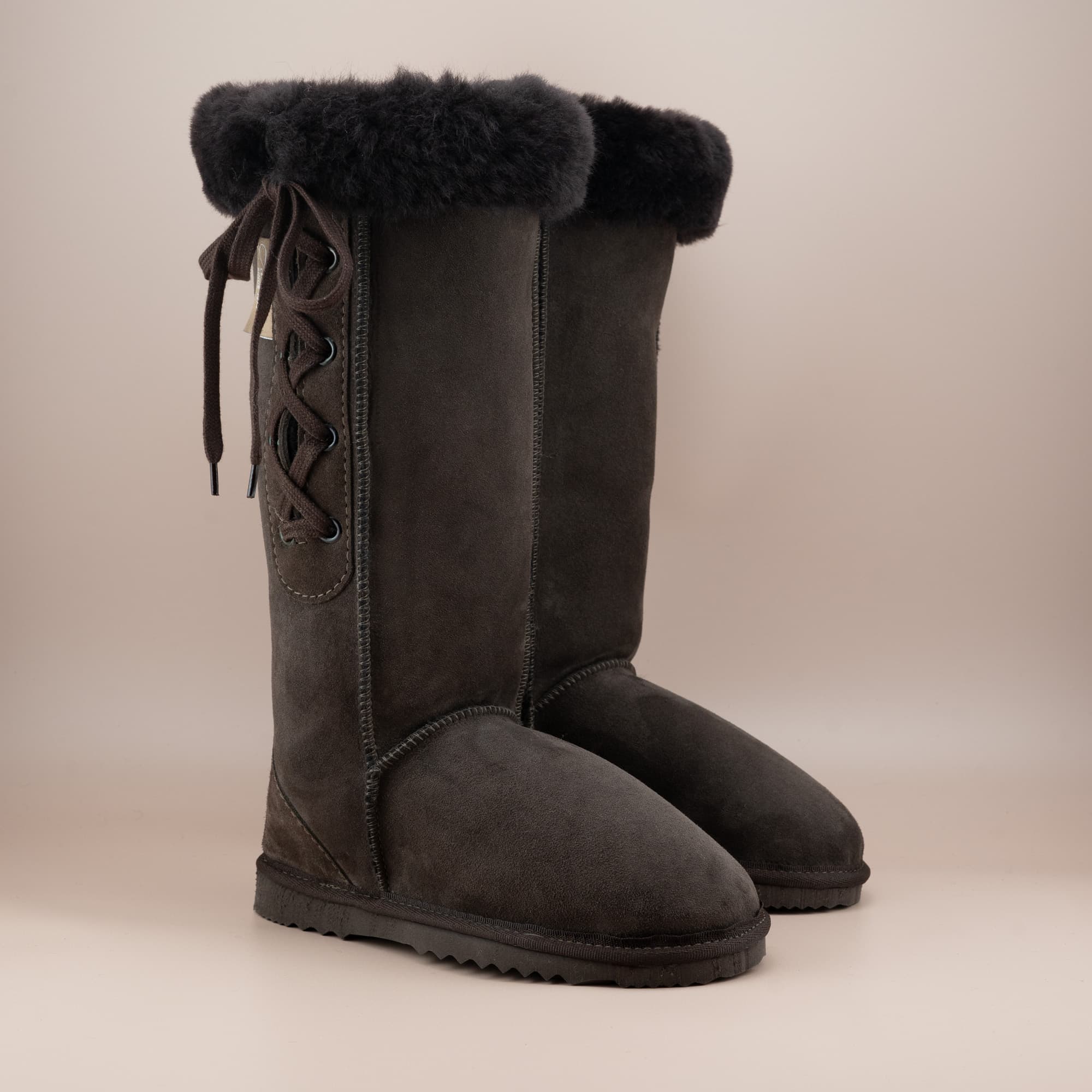 Women's classic long lace-up ugg boot with a cosy wool turn in suede chocolate color, front side view. #color_chocolate