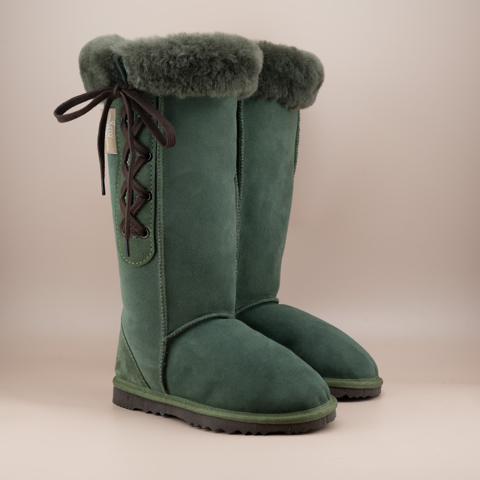 Women's classic long lace-up ugg boot with a cosy wool turn in suede olive color, front side view. #color_olive