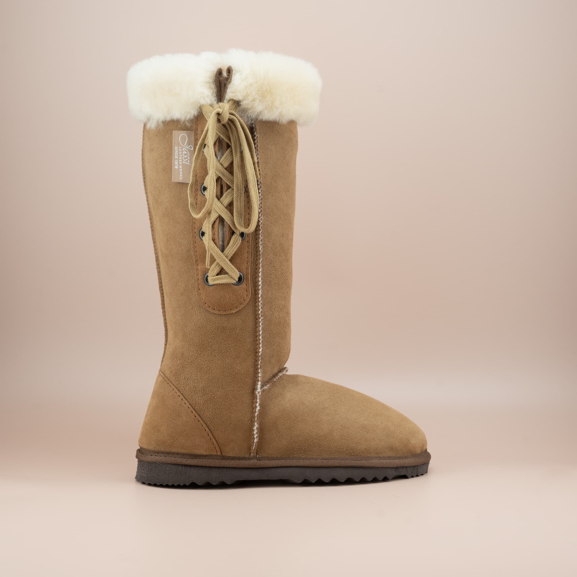 Women's classic long lace-up ugg boot with a cosy wool turn in suede tan color, side view. #color_tan