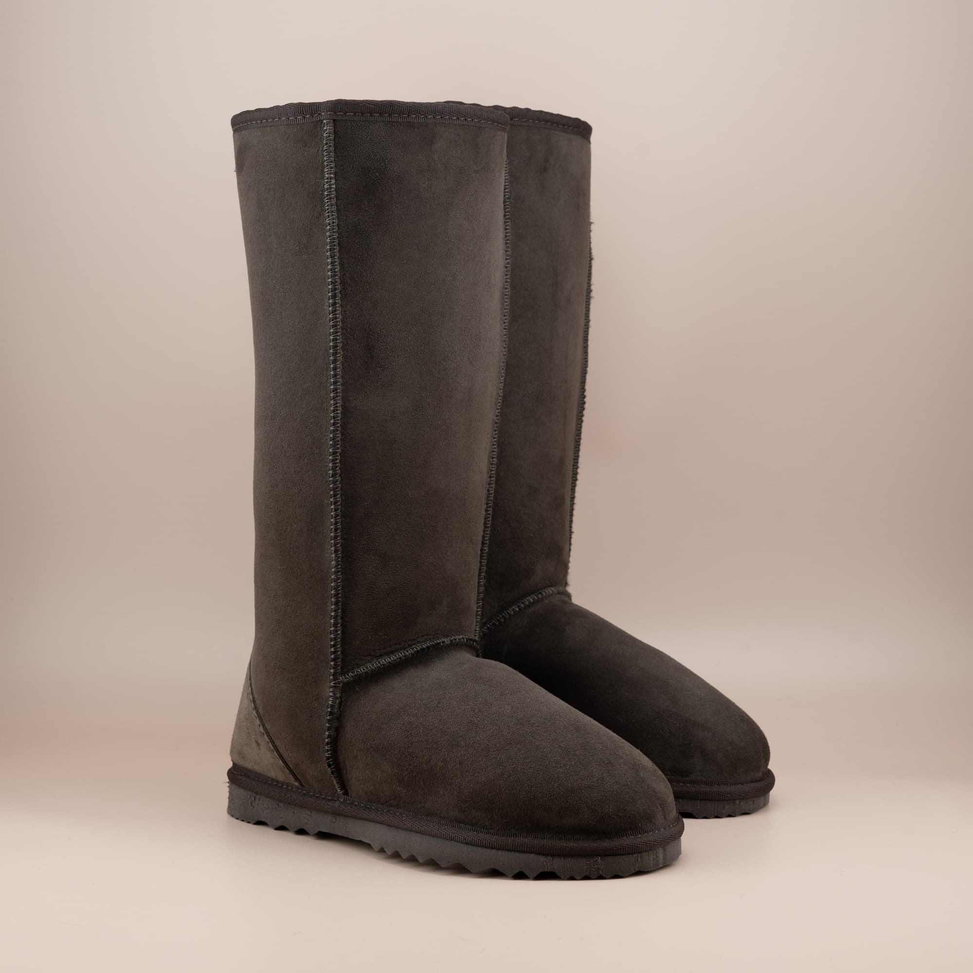 Women's classic long ugg boot in suede chocolate color, front side view. #color_chocolate