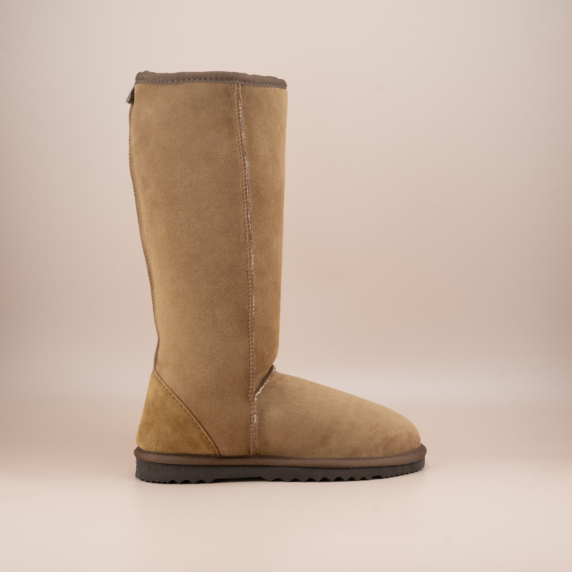 Women's classic long ugg boot in suede tan color, side view. #color_tan