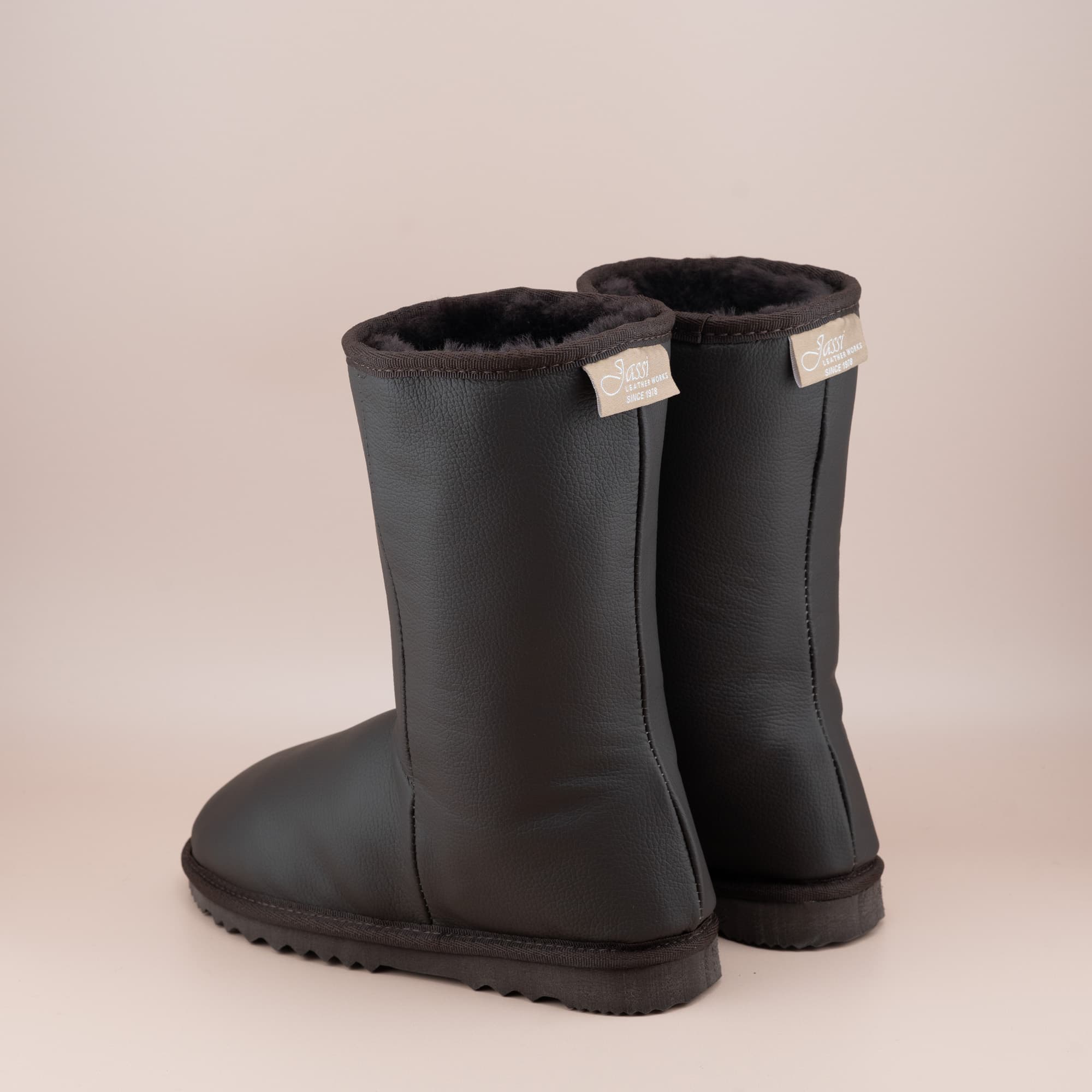 Women's classic mid ugg boots in chocolate leather, back view. #color_leather chocolate