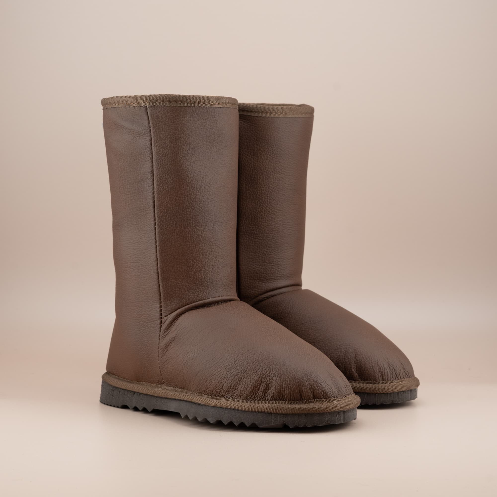 Women's classic mid ugg boots in tan leather, front side view. #color_leather tan