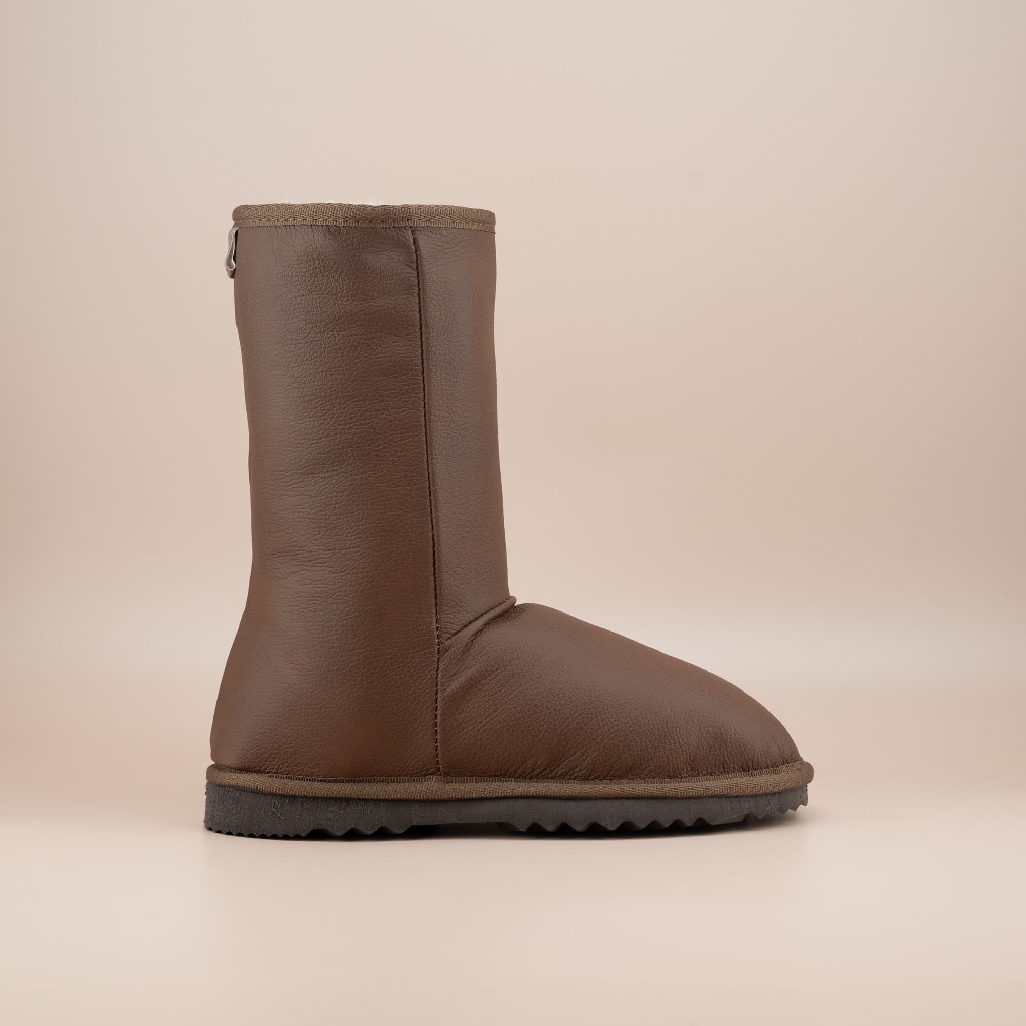 Women's classic mid ugg boots in tan leather, side view. #color_leather tan