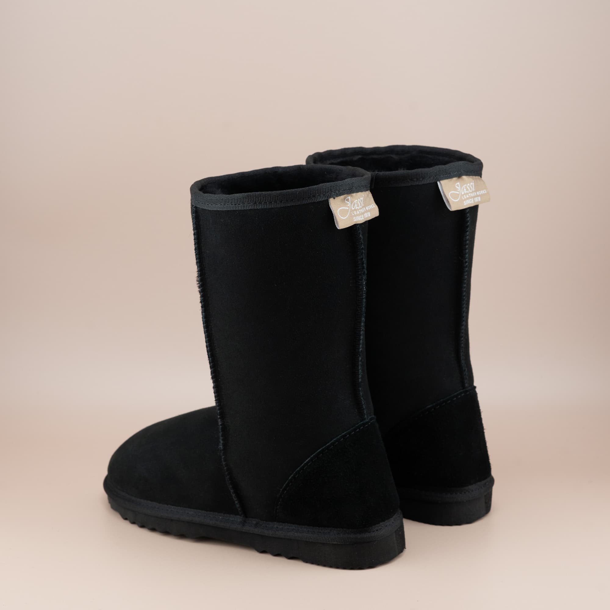 Women's classic mid ugg boot in suede black color, back view. #color_black