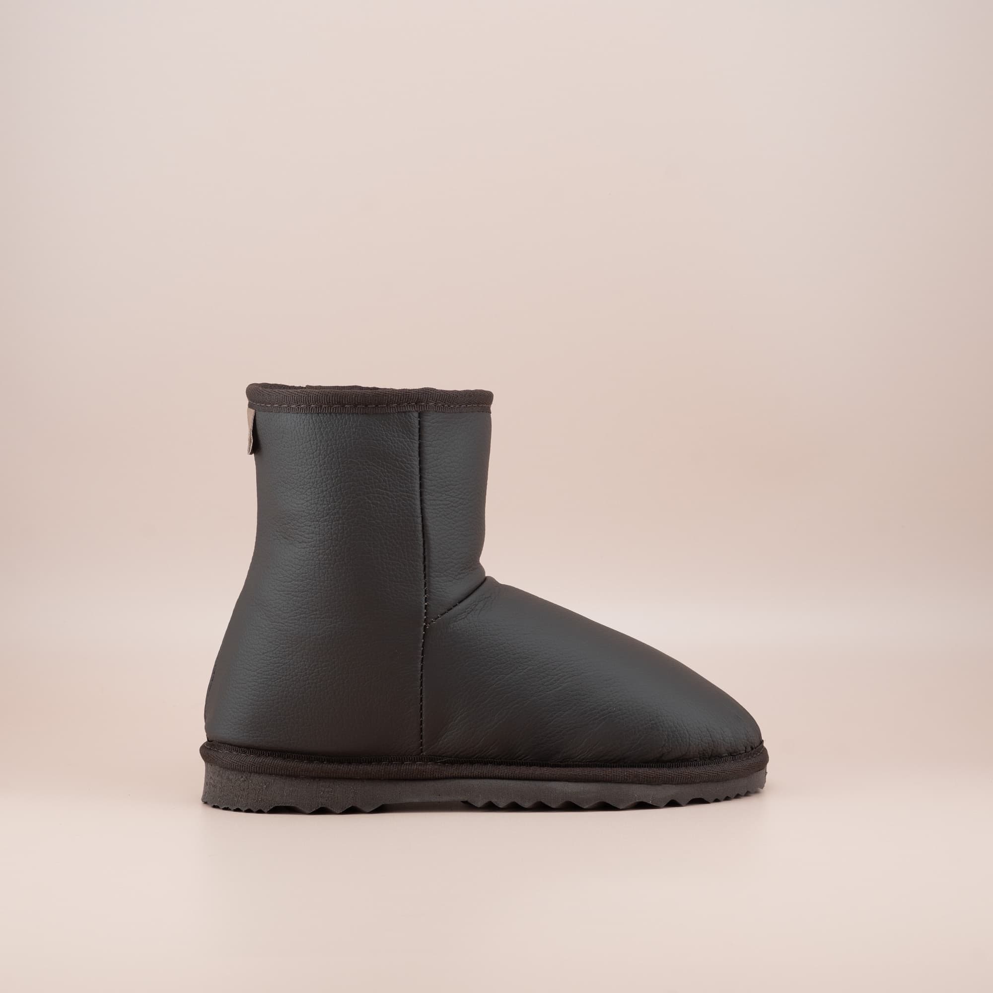 Women's classic short ugg boots in chocolate leather, side view. #color_leather chocolate