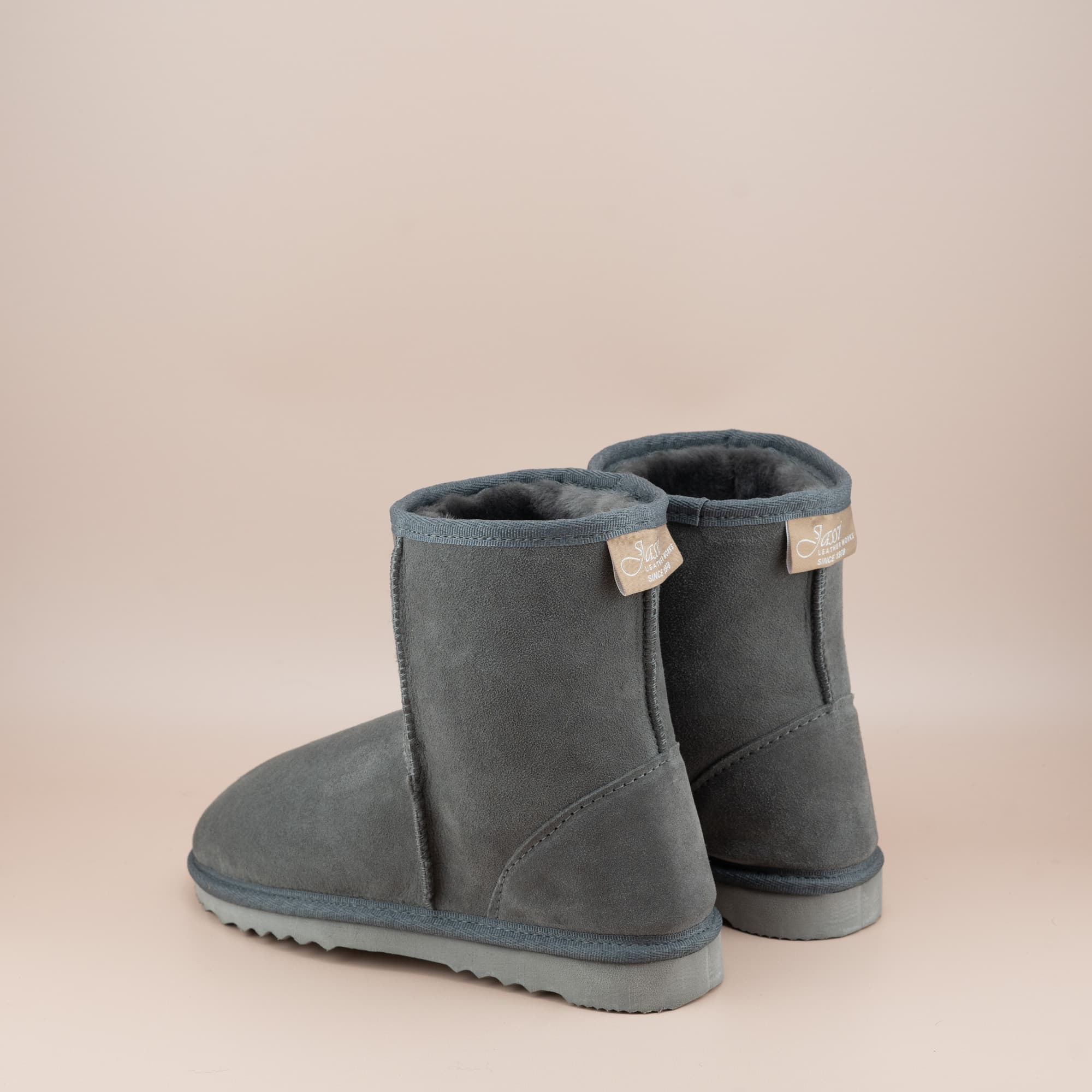 Women's classic short ugg boot in suede grey color, back view. #color_grey