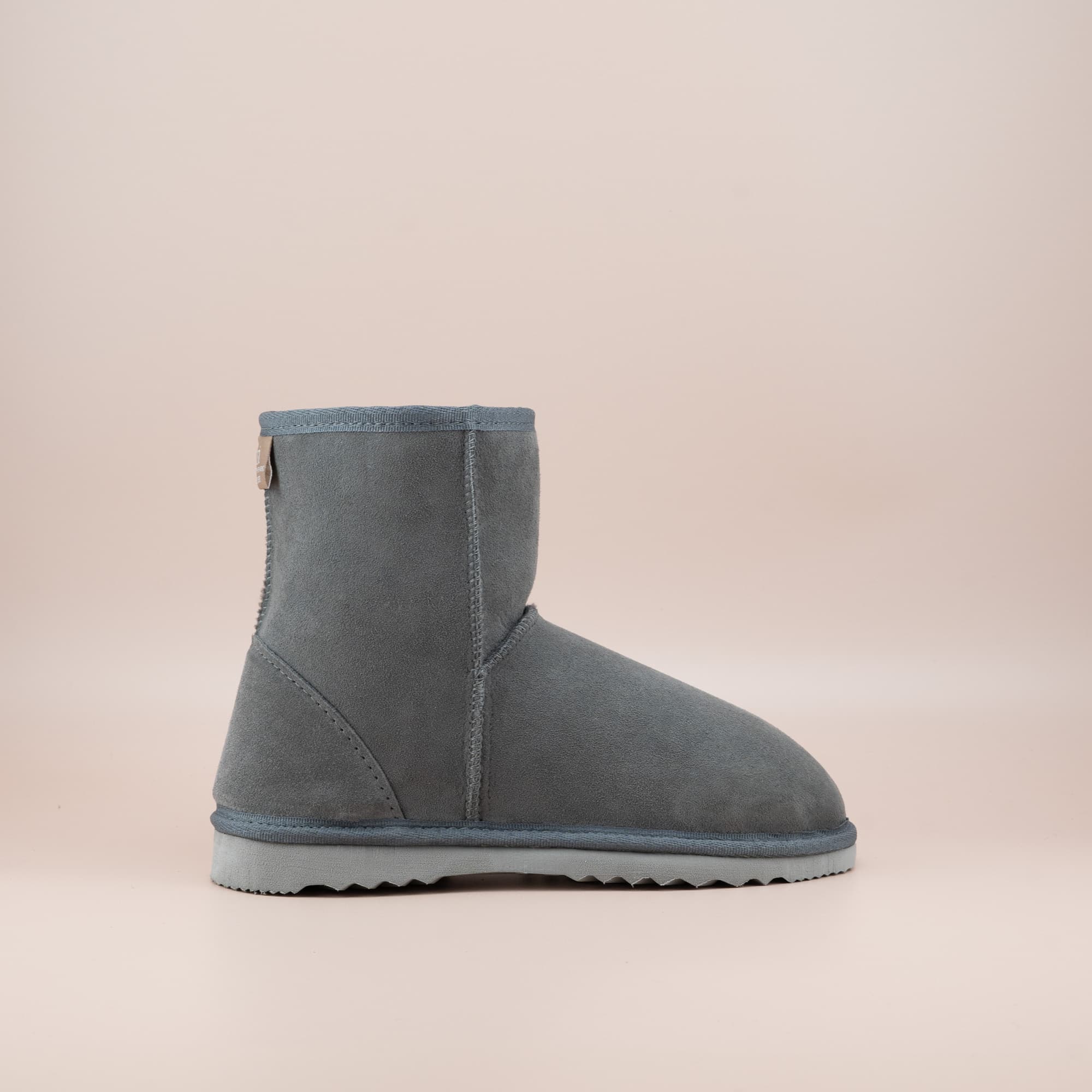 Women's classic short ugg boot in suede grey color, side view. #color_grey