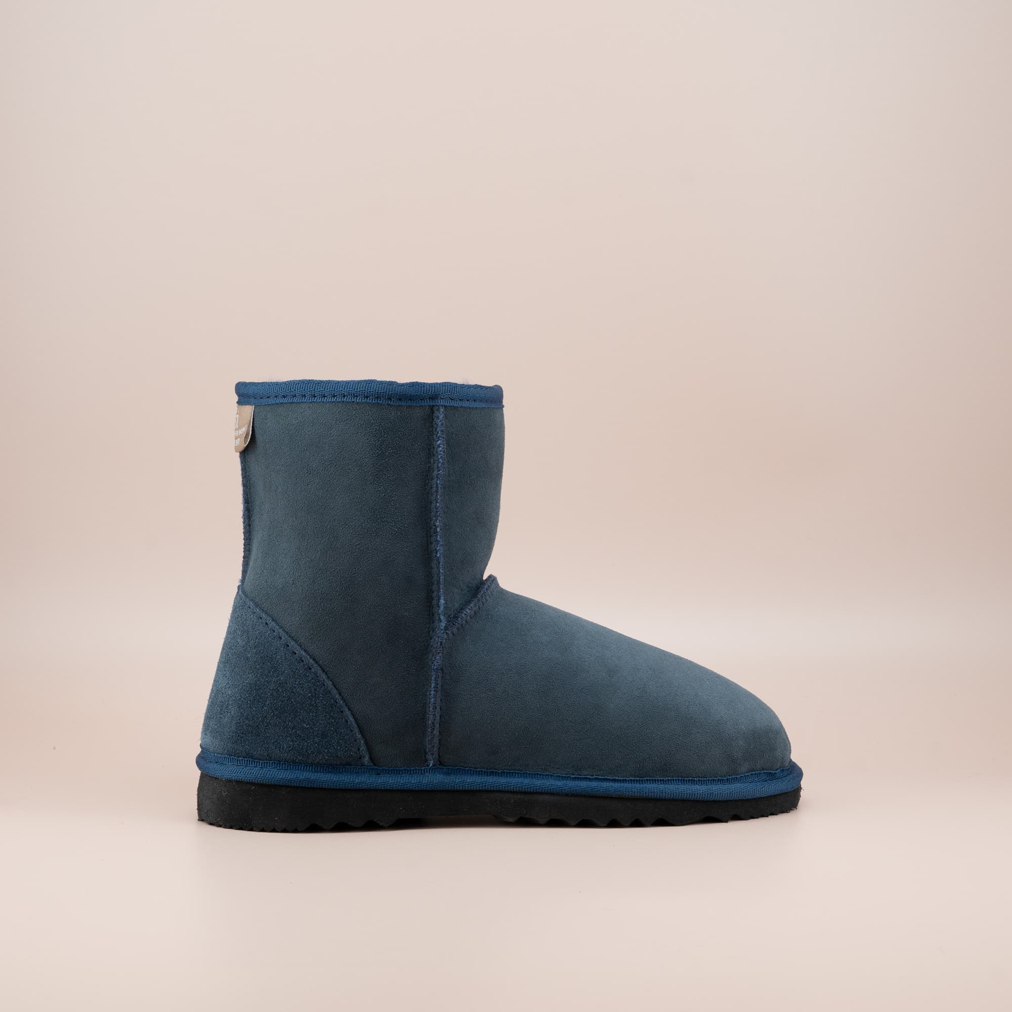 Women's classic short ugg boot in suede navy color, side view. #color_navy