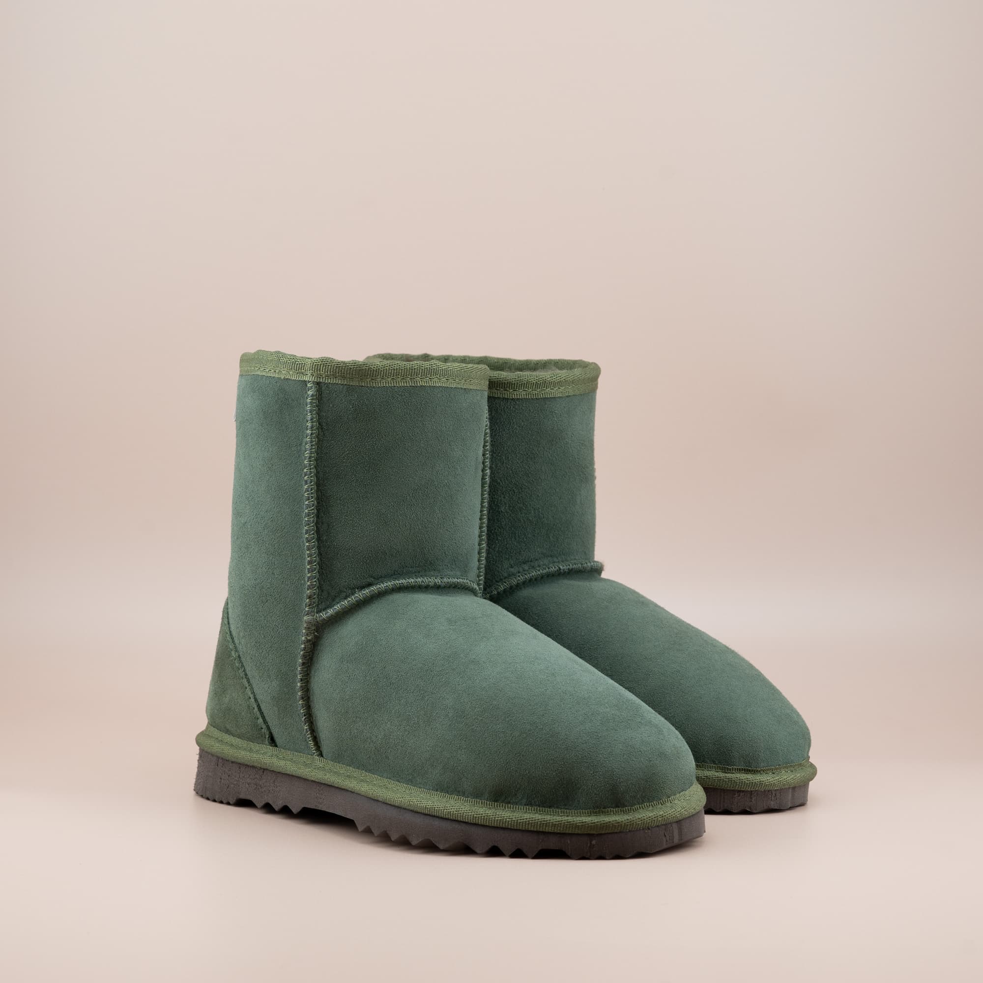 Women's classic short ugg boot in suede olive color, front view. #color_olive