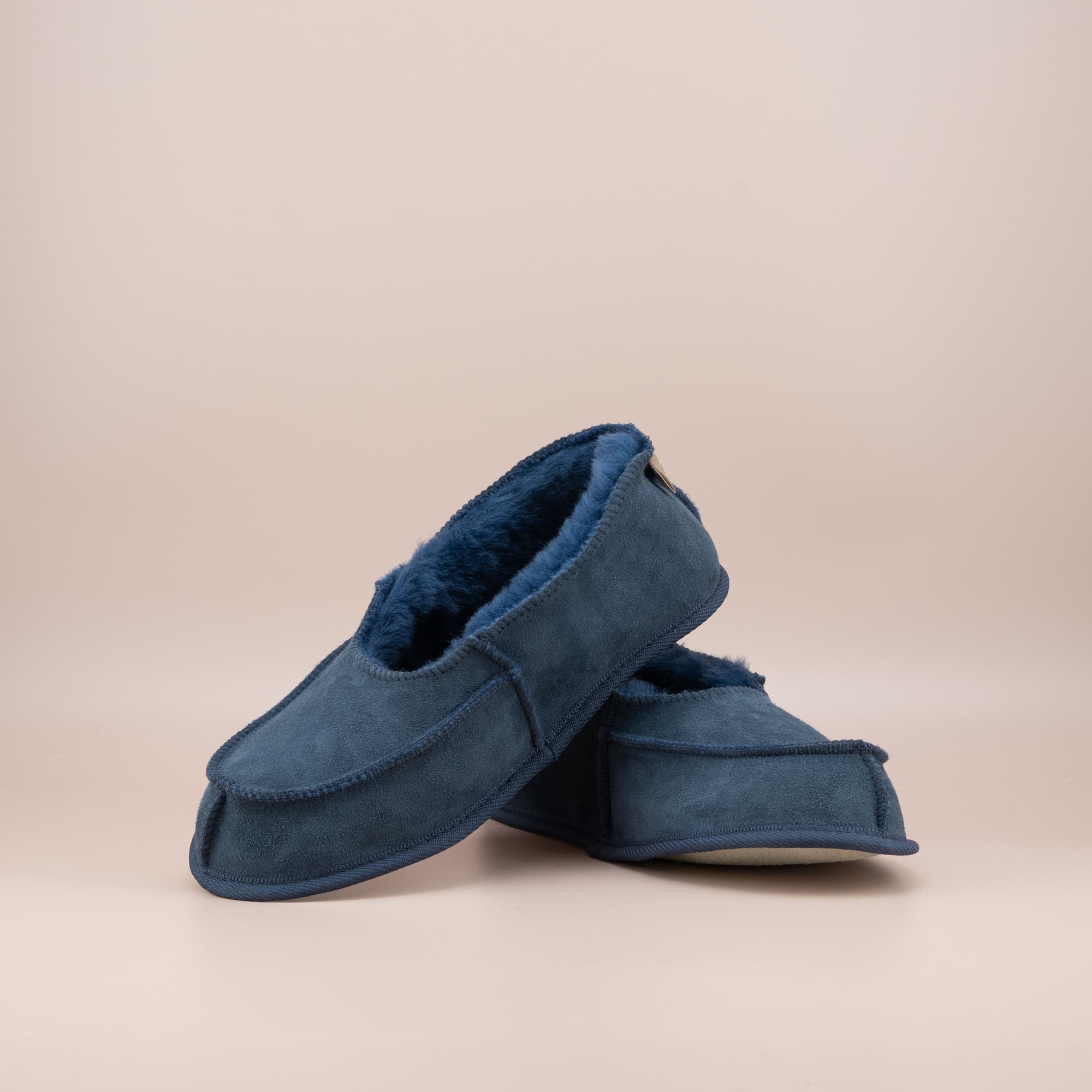 Women's ugg moccasins in navy suede, front and side view of the pair. #color_navy