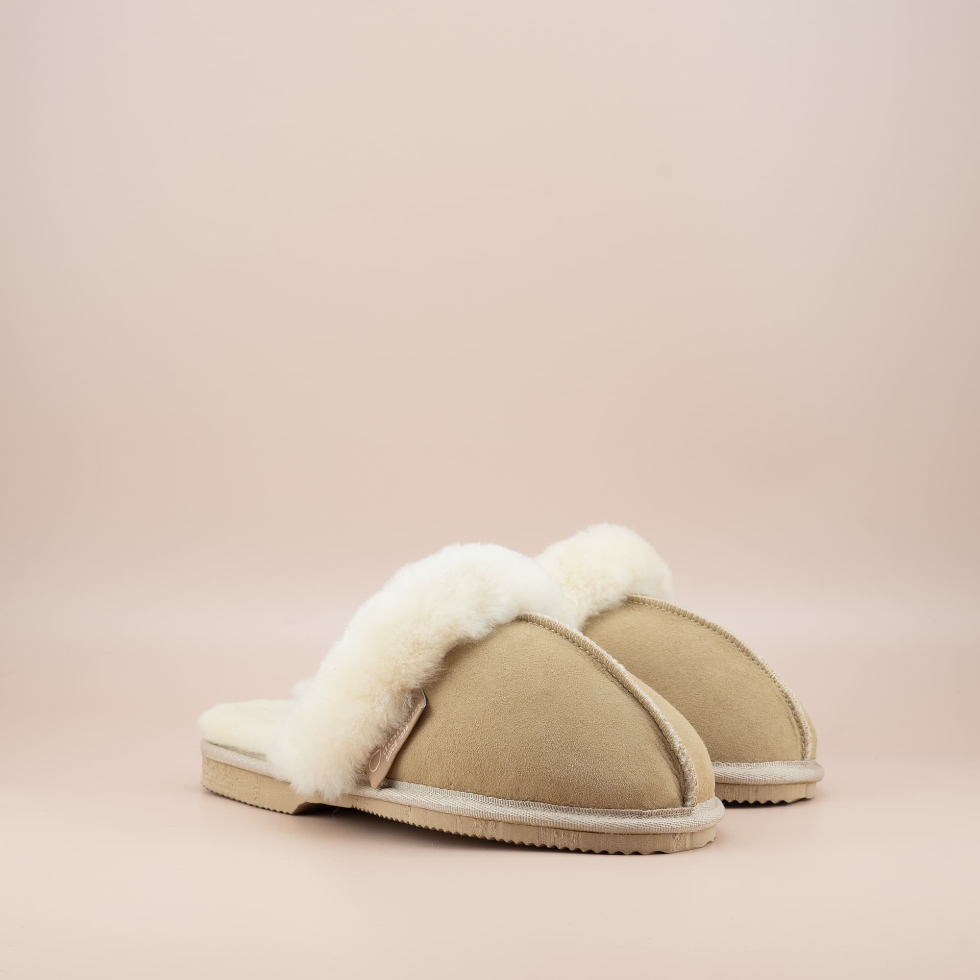 Women's ugg scuffs in sand suede and soft merino wool turn, side view of the pair. #color_sand