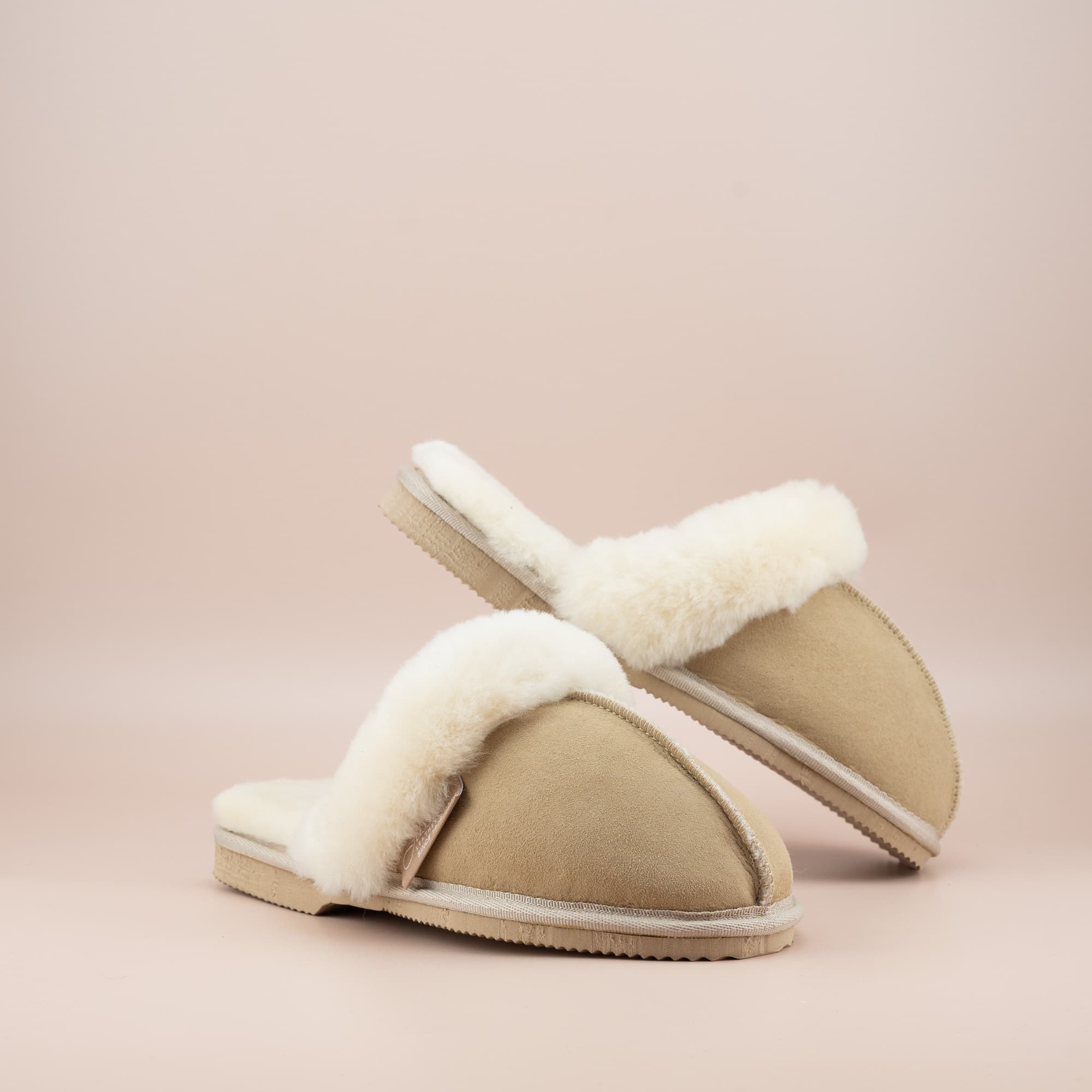 Women's ugg scuffs in sand suede and soft merino wool turn, front and side view of the pair. #color_sand