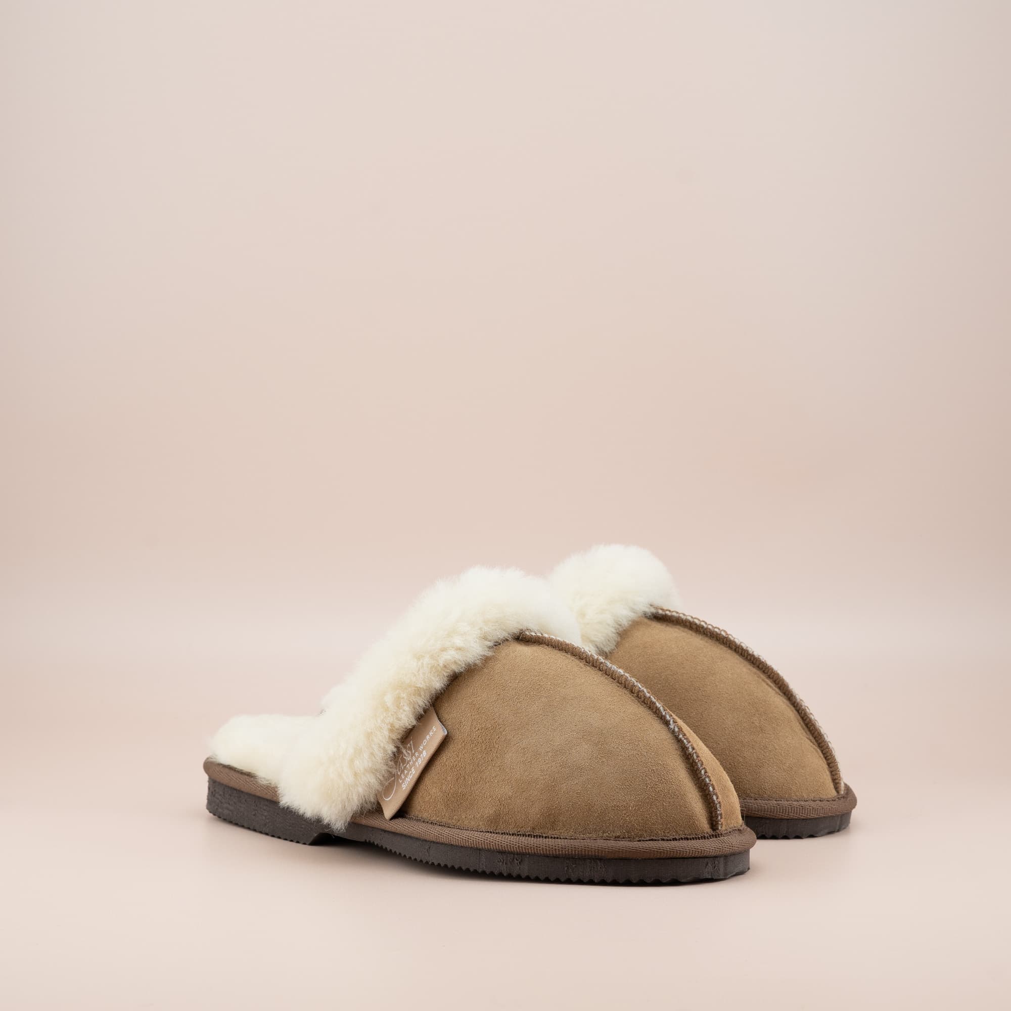 Women's ugg scuffs in tan suede and soft merino wool turn, side view of the pair. #color_tan