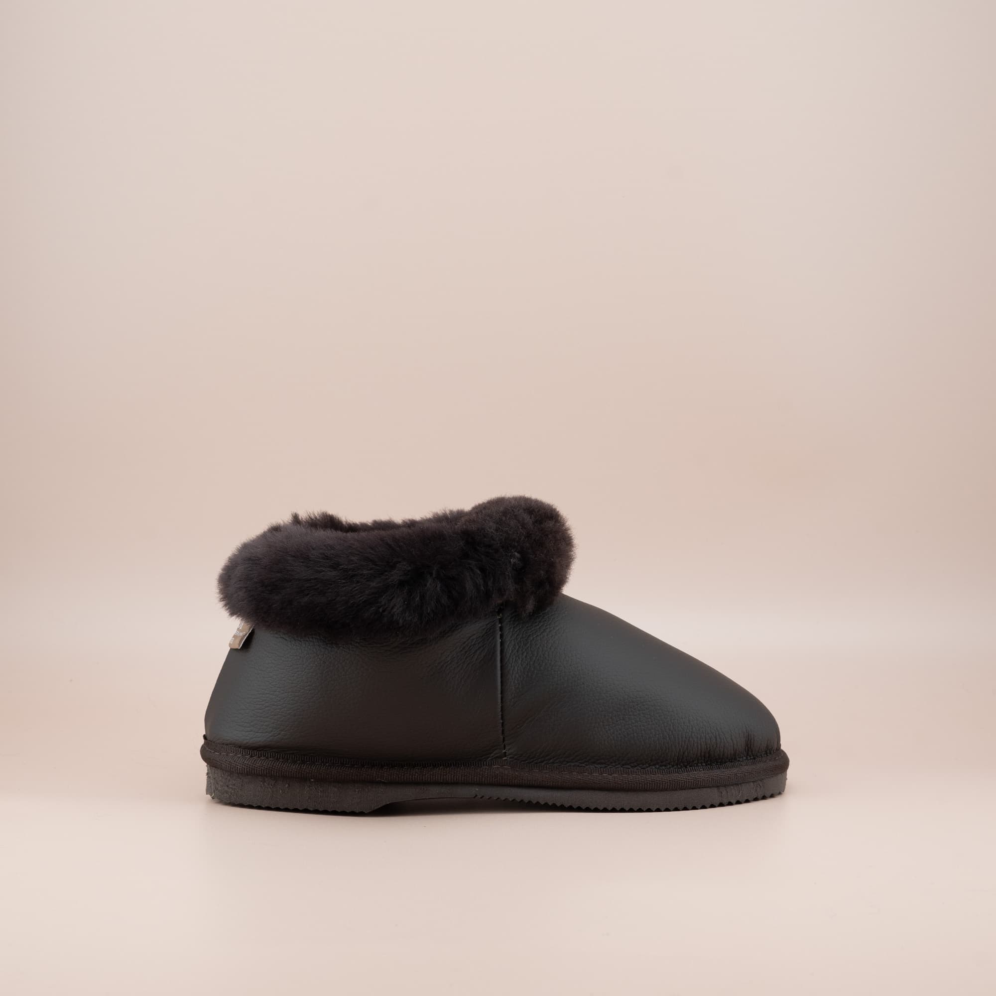 Women's ugg slippers in leather chocolate and a soft wool turn, single side view. #color_leather chocolate