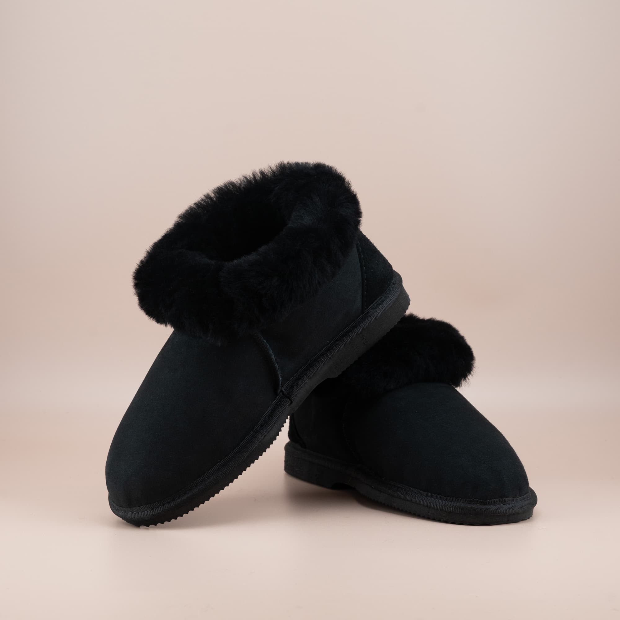 Women's ugg slippers in black suede and wool turn, front and side view. #color_black