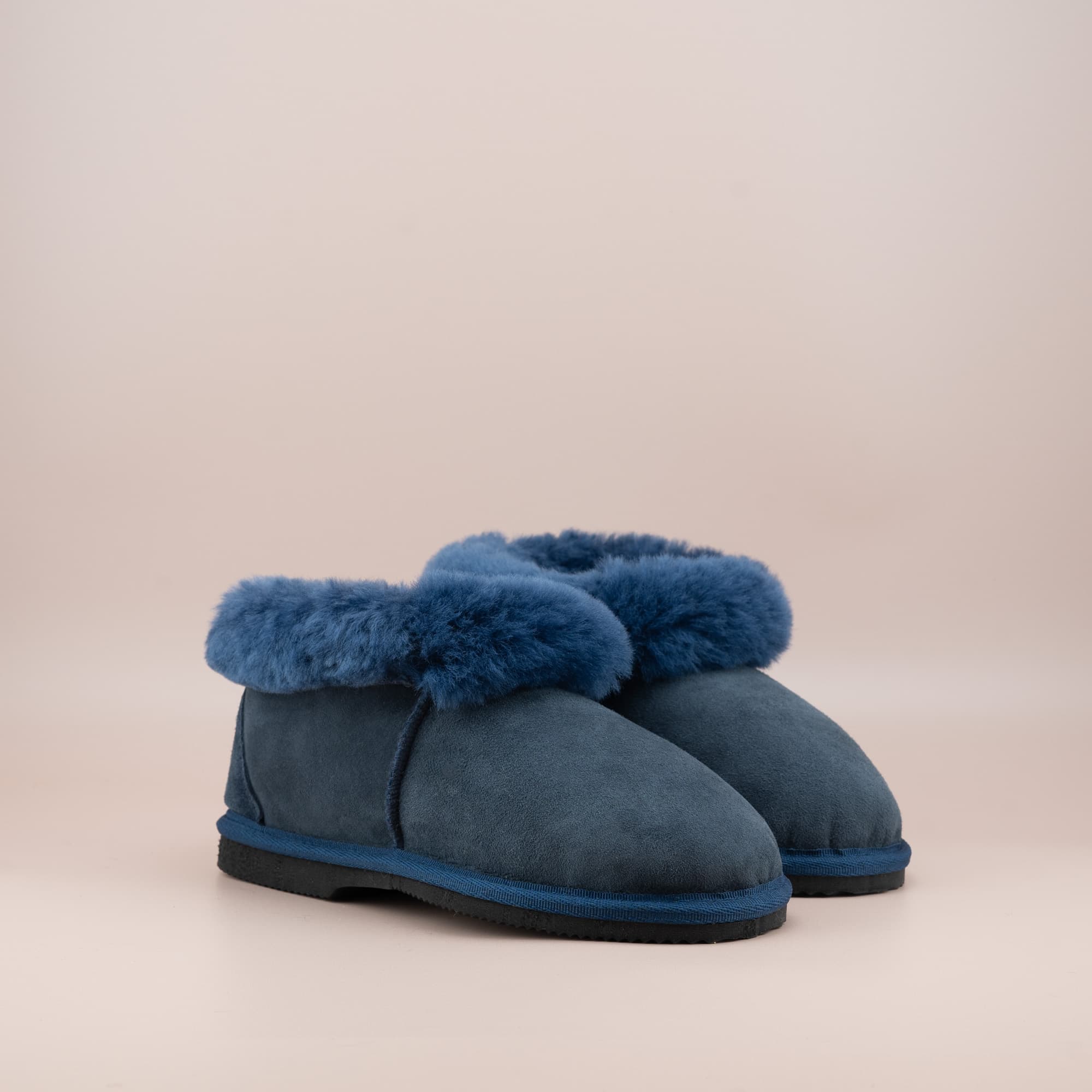 Women's ugg slippers in navy suede and wool turn, side view of the pair. #color_navy